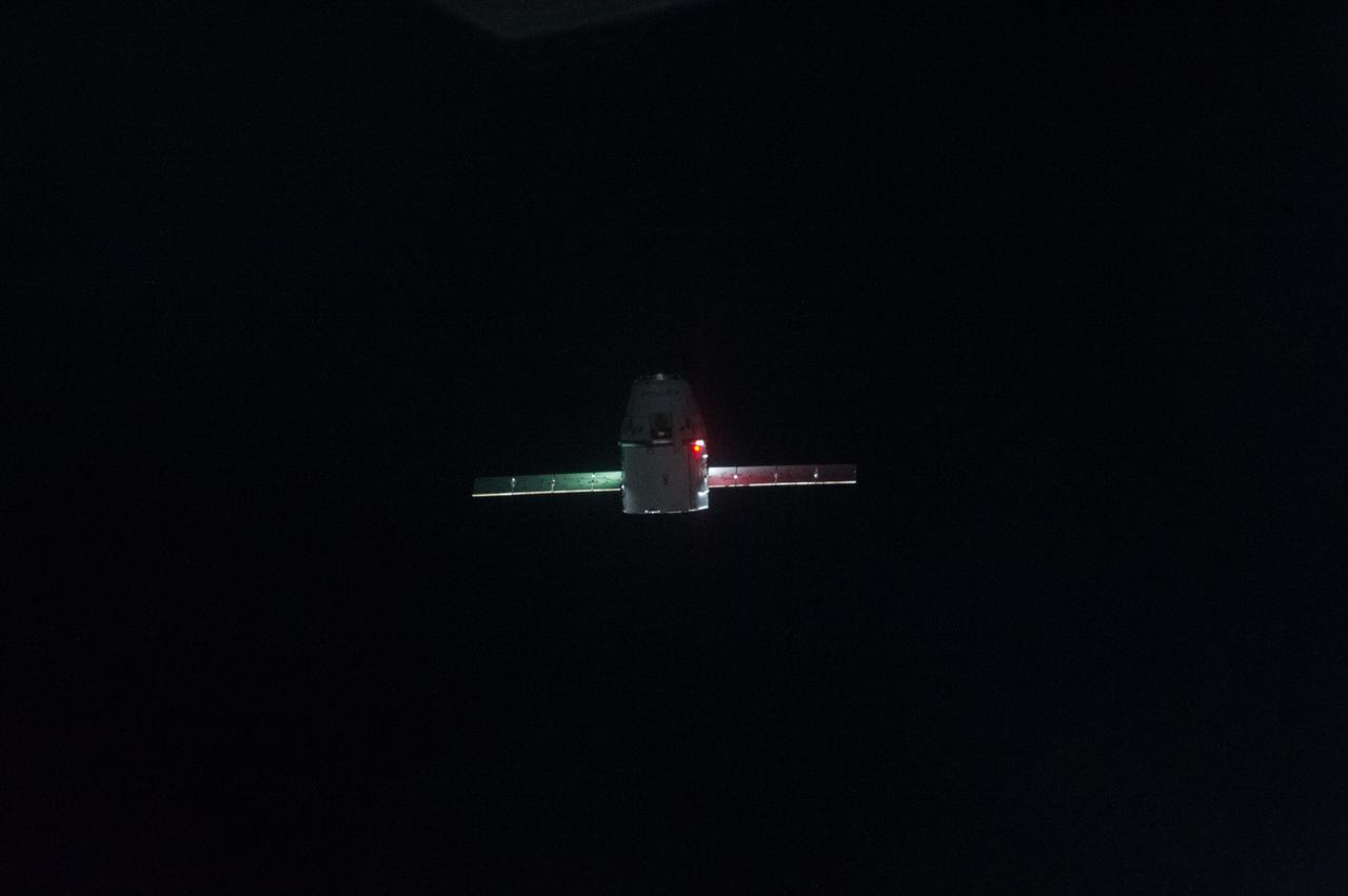 ISS039-E-013352 (20 April 2014) --- This is one of an extensive series of still photos documenting the arrival and ultimate capture and berthing of the SpaceX Dragon at the International Space Station, as photographed by the Expedition 39 crew members onboard the orbital outpost. The spacecraft was captured by the space station and successfully berthed, following the April 20 arrival.