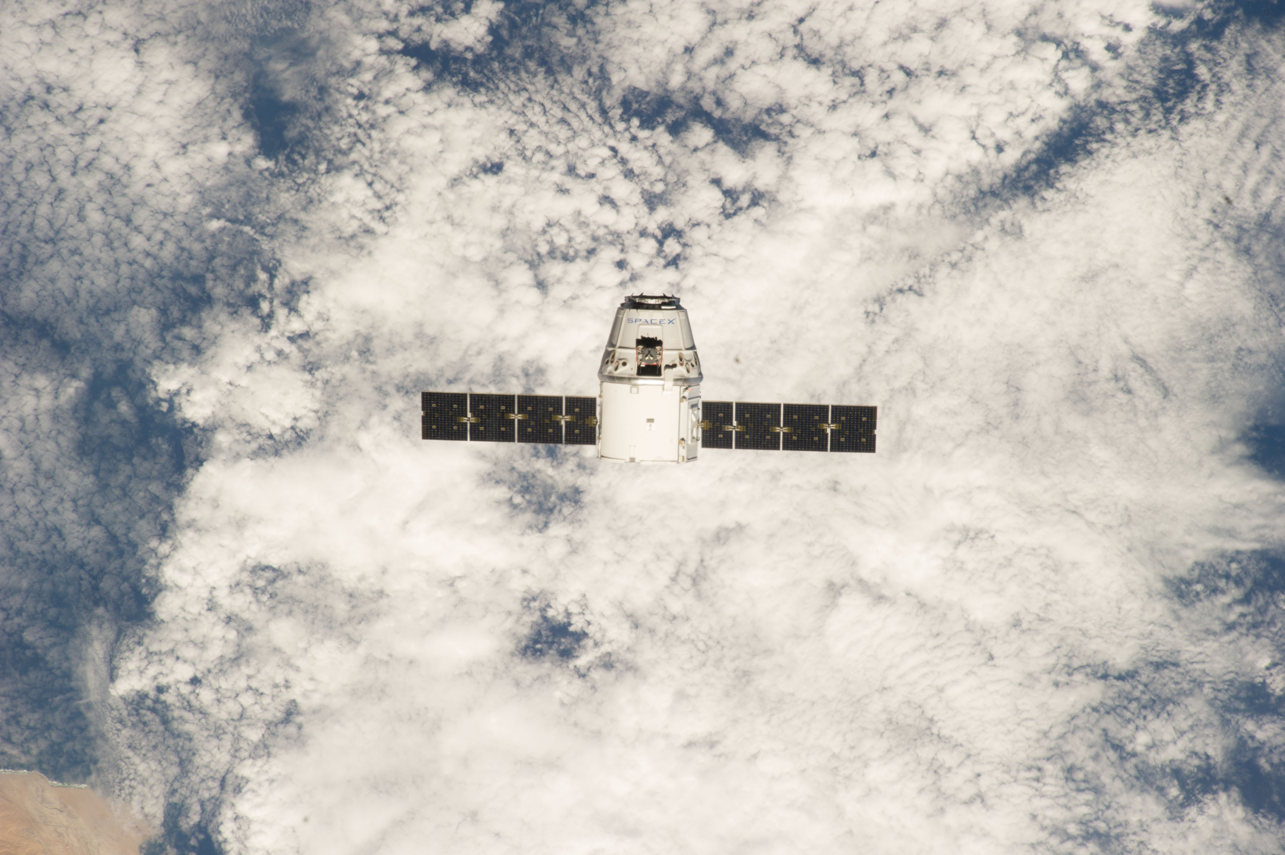 ISS039-E-013377 (20 April 2014) --- This is one of an extensive series of still photos documenting the arrival and ultimate capture and berthing of the SpaceX Dragon at the International Space Station, as photographed by the Expedition 39 crew members onboard the orbital outpost. The spacecraft was captured by the space station and successfully berthed, following the April 20 arrival.