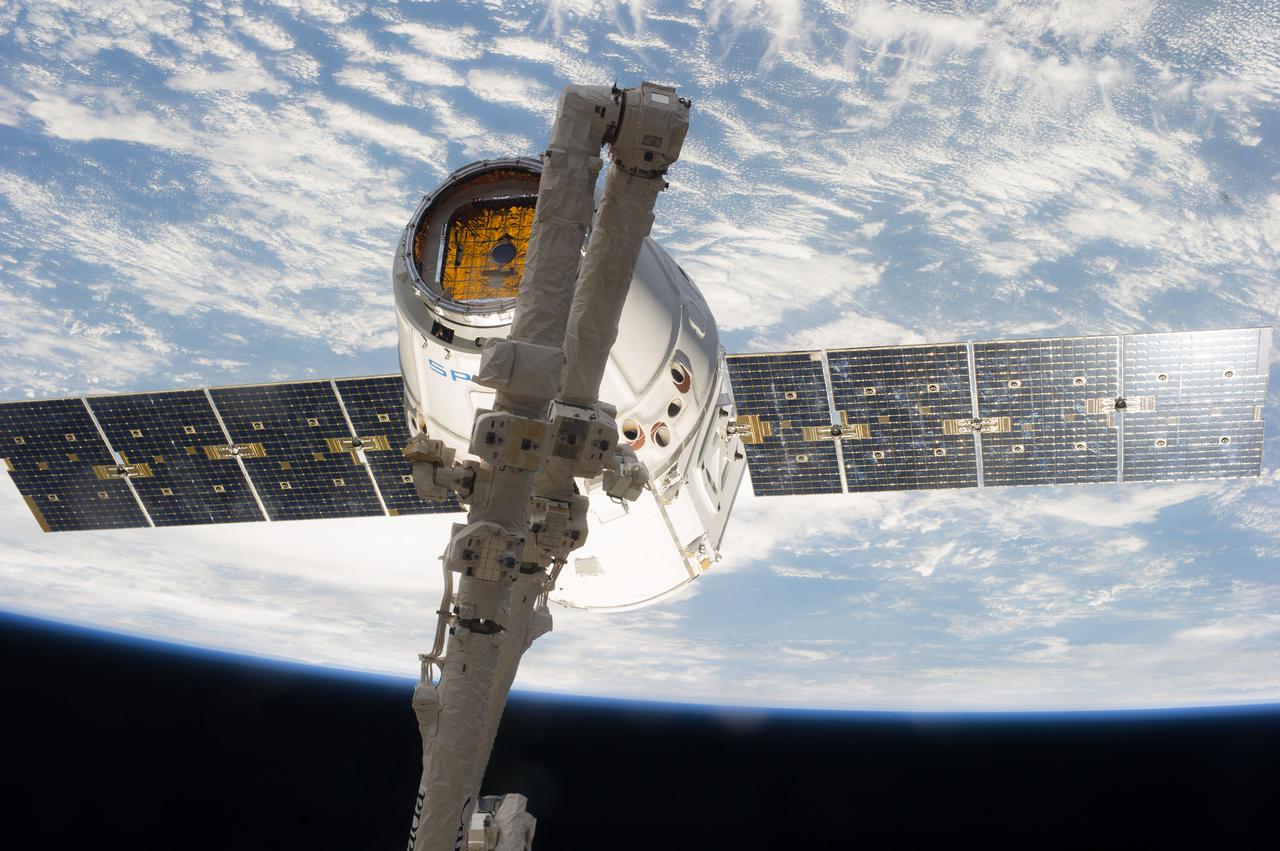 ISS039-E-013501 (20 April 2014) --- This is one of an extensive series of still photos documenting the arrival and ultimate capture and berthing of the SpaceX Dragon at the International Space Station, as photographed by the Expedition 39 crew members onboard the orbital outpost. The spacecraft was captured by the space station and successfully berthed, following the April 20 arrival.