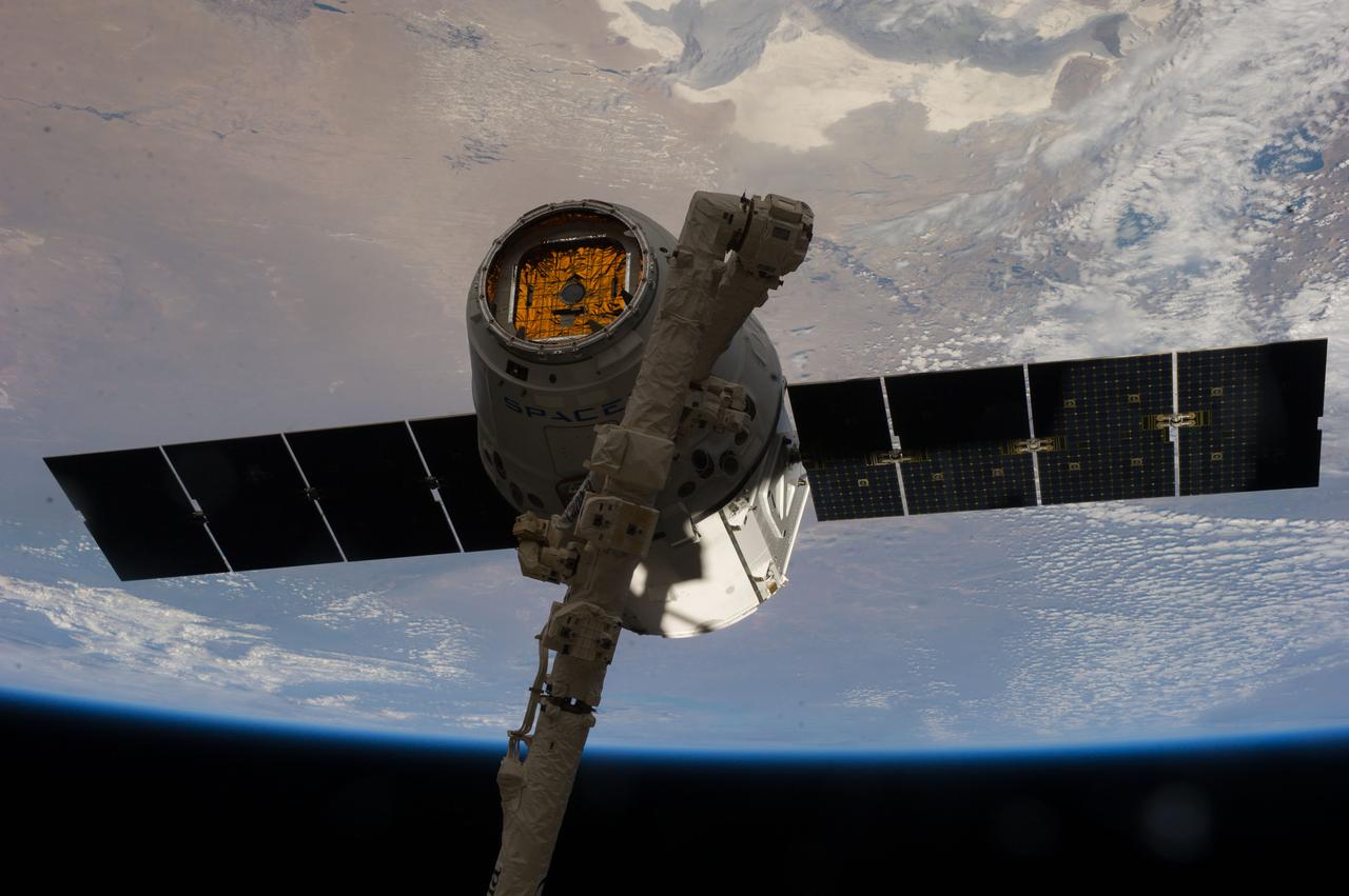 View of the SpaceX Dragon Commercial Resupply Services-3 (CRS-3) spacecraft grappled by the Canadarm2 Space Station Remote Manipulator System (SSRMS) during Expedition 39. Image was released by released by flight engineer 3 (FE3) on Instagram.