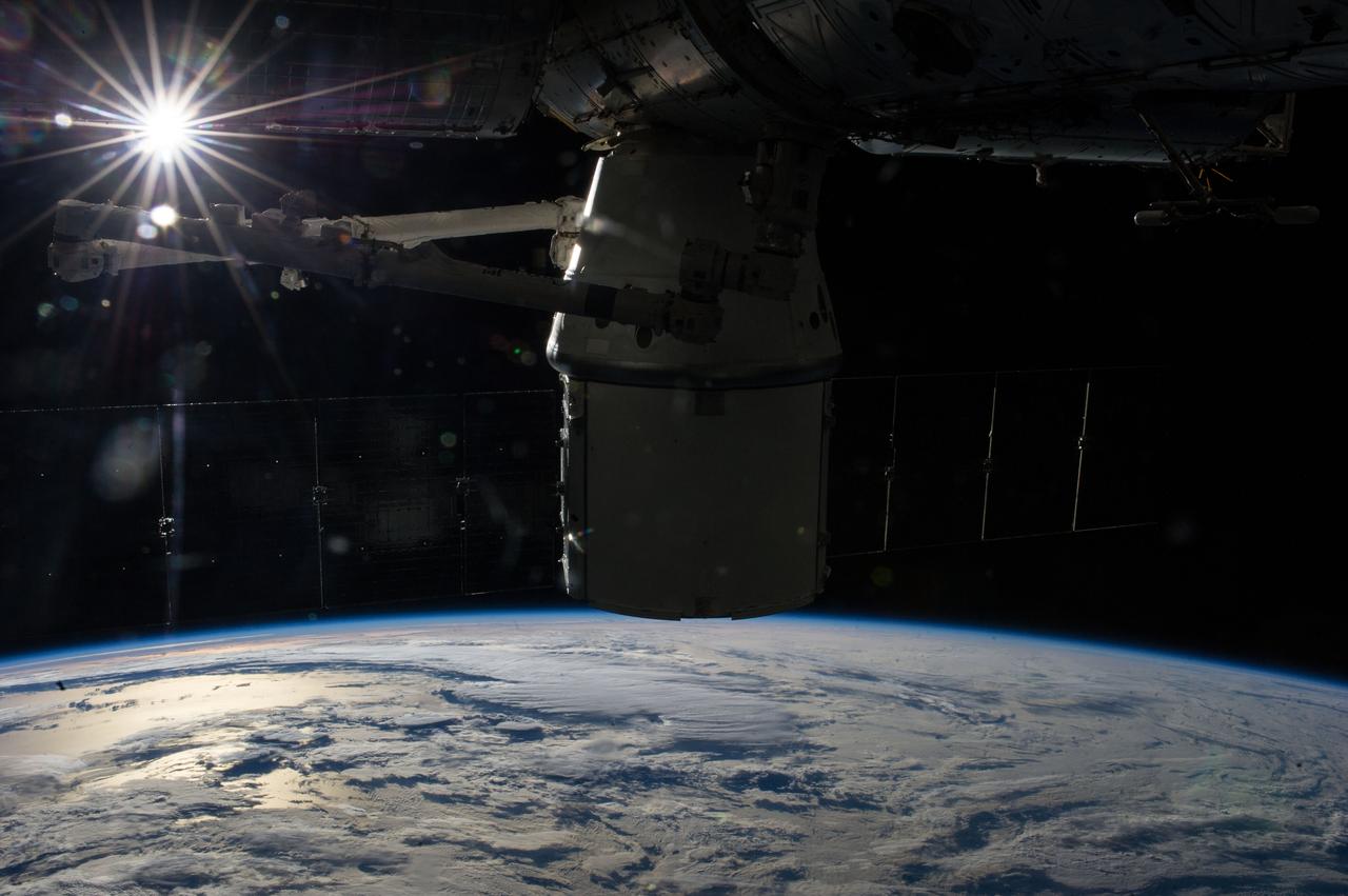 ISS039-E-013536 (20 April 2014) --- The sun appears brightly in the upper left corner of this photo -- one of an extensive series of still photos documenting the arrival and ultimate capture and berthing of the SpaceX Dragon at the International Space Station, as photographed by the Expedition 39 crew members onboard the orbital outpost. The spacecraft was captured by the space station and successfully berthed following the April 20 arrival.