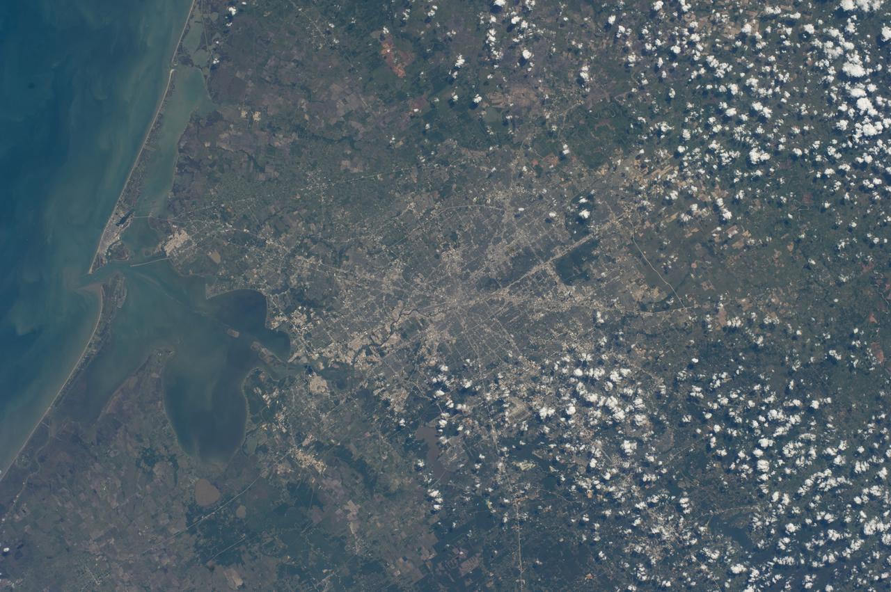 ISS039-E-013926 (18 April 2014) --- One of the Expedition 39 crew members aboard the International Space Station photographed this vertical view of the greater Houston metropolitan area on April 18, 2014. Harris County, Galveston County and several other southeast Texas counties are visible in the scene. Houston's central business district or "downtown" is near center frame and part of the Gulf of Mexico Coast occupies most of the left side of the image.
