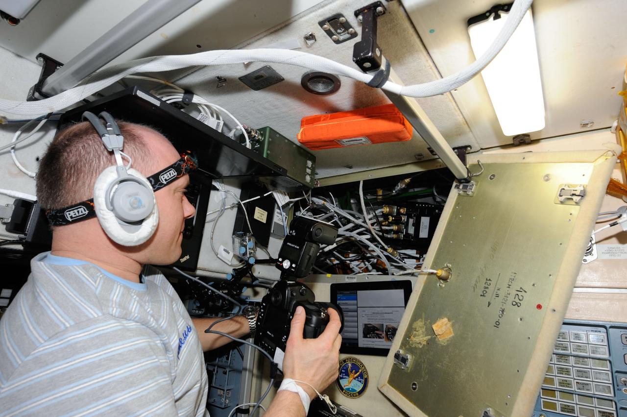 ISS039-E-014665 (23 April 2014) --- Cosmonaut Artemyev, Expedition 39 flight engineer representing Russia's Federal Space Agency (Roscosmos) replaces the telemetry storage unit in a Russian experiment inside the Zvezda service module of the International Space Station.