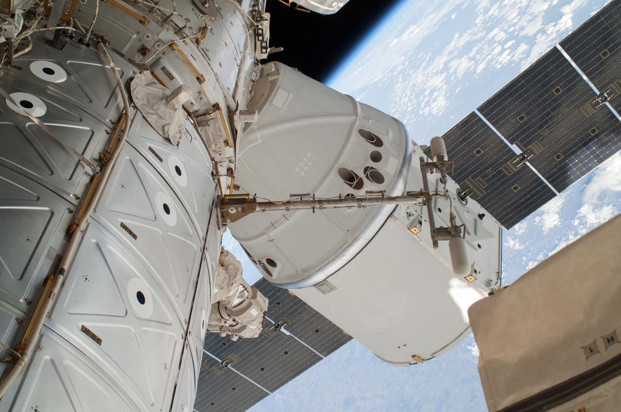 View of the SpaceX Dragon Commercial Resupply Services-3 (CRS-3) spacecraft and portions of the Destiny U.S. Laboratory and Harmony Node 2 taken against a backdrop of Earth and space by Extravehicular crewmember 1 (EV1) during Extravehicular Activity 26 (EVA 26).