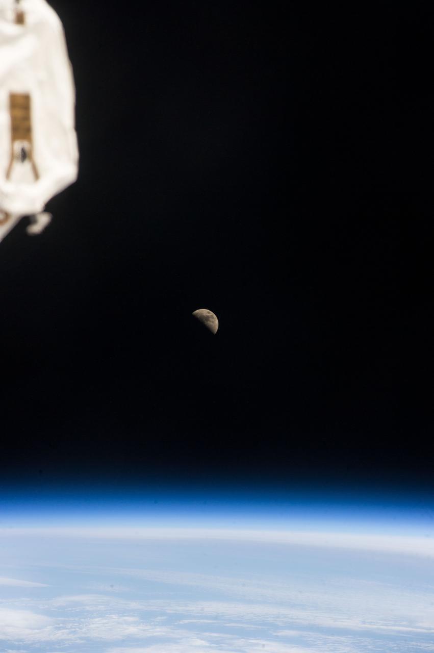 ISS039-E-018938 (6 May 2014) --- One of the Expedition 39 crew members aboard the International Space Station photographed a half moon above Earth's horizon on May 6, 2014.