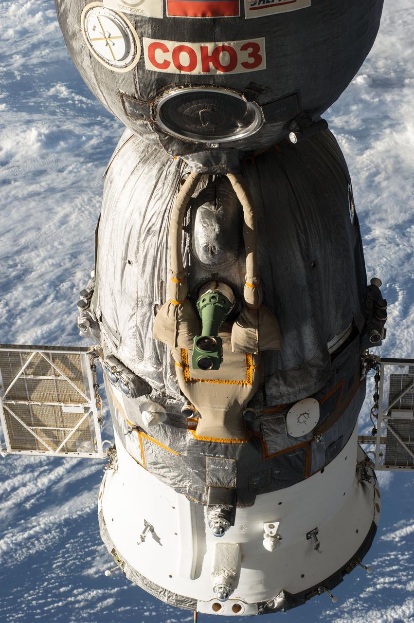 ISS039-E-019122 (5 May 2014) --– A Russian Soyuz spacecraft is seen docked to the International Space Station, as photographed by one of the Expedition 39 crew members aboard the orbital outpost. The Soyuz's periscope is in the center of the vehicle.