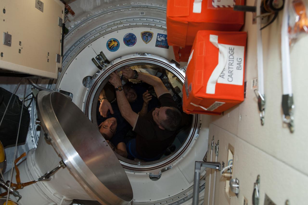 ISS039-E-020779 (13 May 2014) --- The three departing Expedition 39 crew members are seen  just before hatch closing that separates the trio from the remaining crew of three on the International Space Station.  Getting ready to depart in their Soyuz TMA-11M, from left to right, are Flight Engineer Rick Mastracchio of NASA, Expedition 39 Commander Koichi Wakata of the Japan Aerospace Exploration Agency (JAXA) and  Soyuz Commander Mikhail Tyurin of Russia's federal Space Agency (Roscosmos).