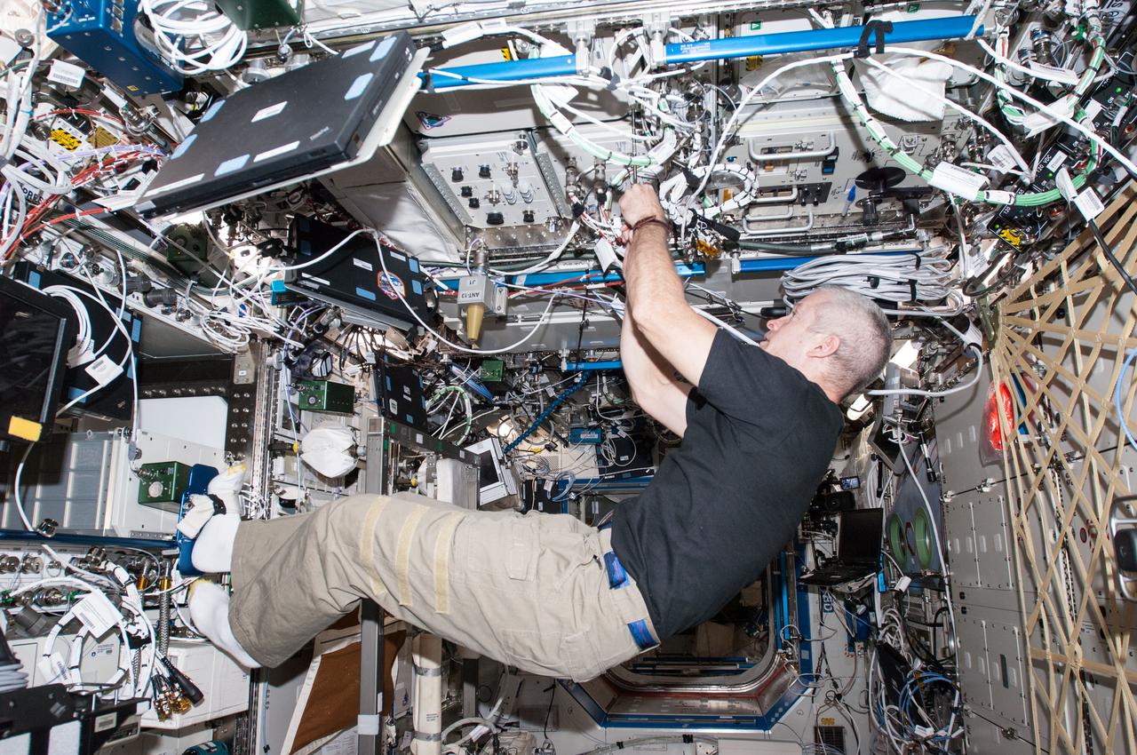 ISS040-E-000296 (16 May 2014) --- NASA astronaut Steve Swanson, Expedition 40 commander, works with the General Laboratory Active Cryogenic ISS Experiment Refrigerator (GLACIER) in the Destiny laboratory of the International Space Station.