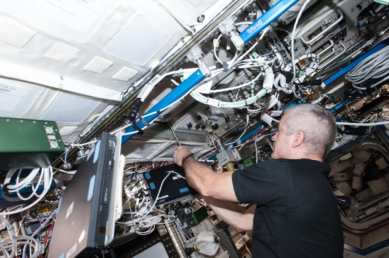 ISS040-E-000297 (16 May 2014) --- NASA astronaut Steve Swanson, Expedition 40 commander, works with the General Laboratory Active Cryogenic ISS Experiment Refrigerator (GLACIER) in the Destiny laboratory of the International Space Station.