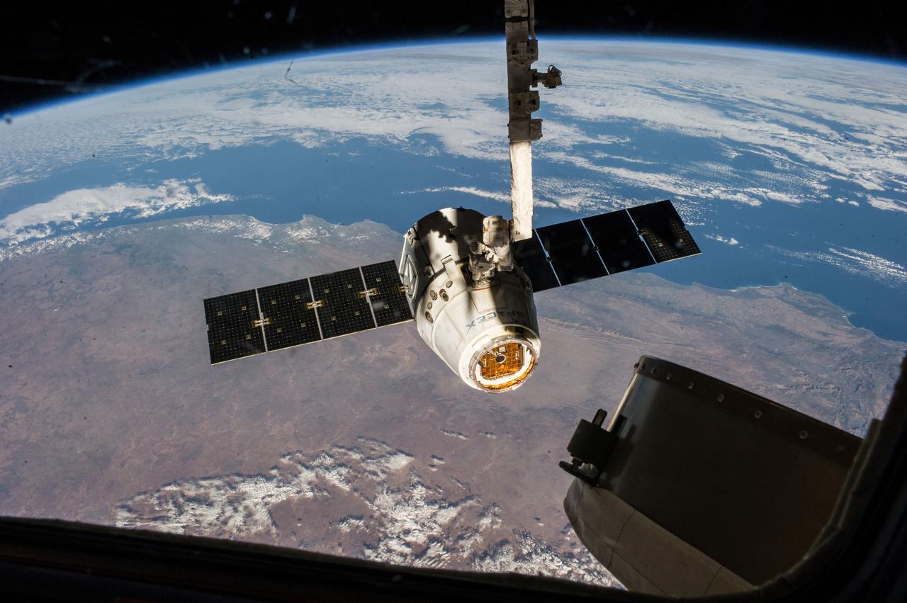 ISS040-E-000404 (18 May 2014) --- The SpaceX Dragon commercial cargo craft is pictured just prior to being released by the International Space Station's Canadarm2 robotic arm on May 18, 2014, to allow it to head toward a splashdown in the Pacific Ocean.  South Africa can be seen as the land mass in the picture.
