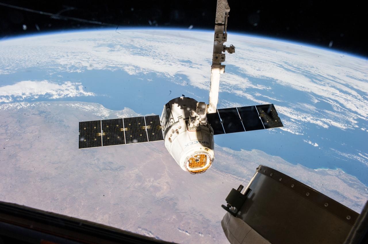 ISS040-E-000407 (18 May 2014) --- The SpaceX Dragon commercial cargo craft is pictured just prior to being released by the International Space Station's Canadarm2 robotic arm on May 18, 2014, to allow it to head toward a splashdown in the Pacific Ocean.  South Africa can be seen as the land mass in the picture.