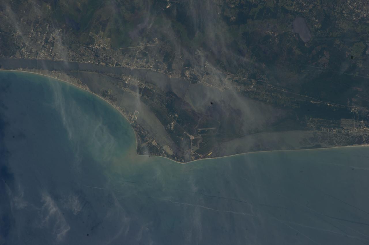 ISS040-E-000465 (17 May 2014) --- One of the Expedition 40 crew members aboard the International Space Station recorded this view of the Atlantic Coast of Florida.  Thin clouds over the Cape Canaveral/Kennedy Space Center area do not obstruct the view of Launch Complex 39 (bottom center), from which 135 space shuttle missions lifted off between 1981 and 2011. Appearing about the size of a pinhead, nearby can be seen the giant Vehicle Assembly Building, which has a history that goes back to the beginning of Apollo.