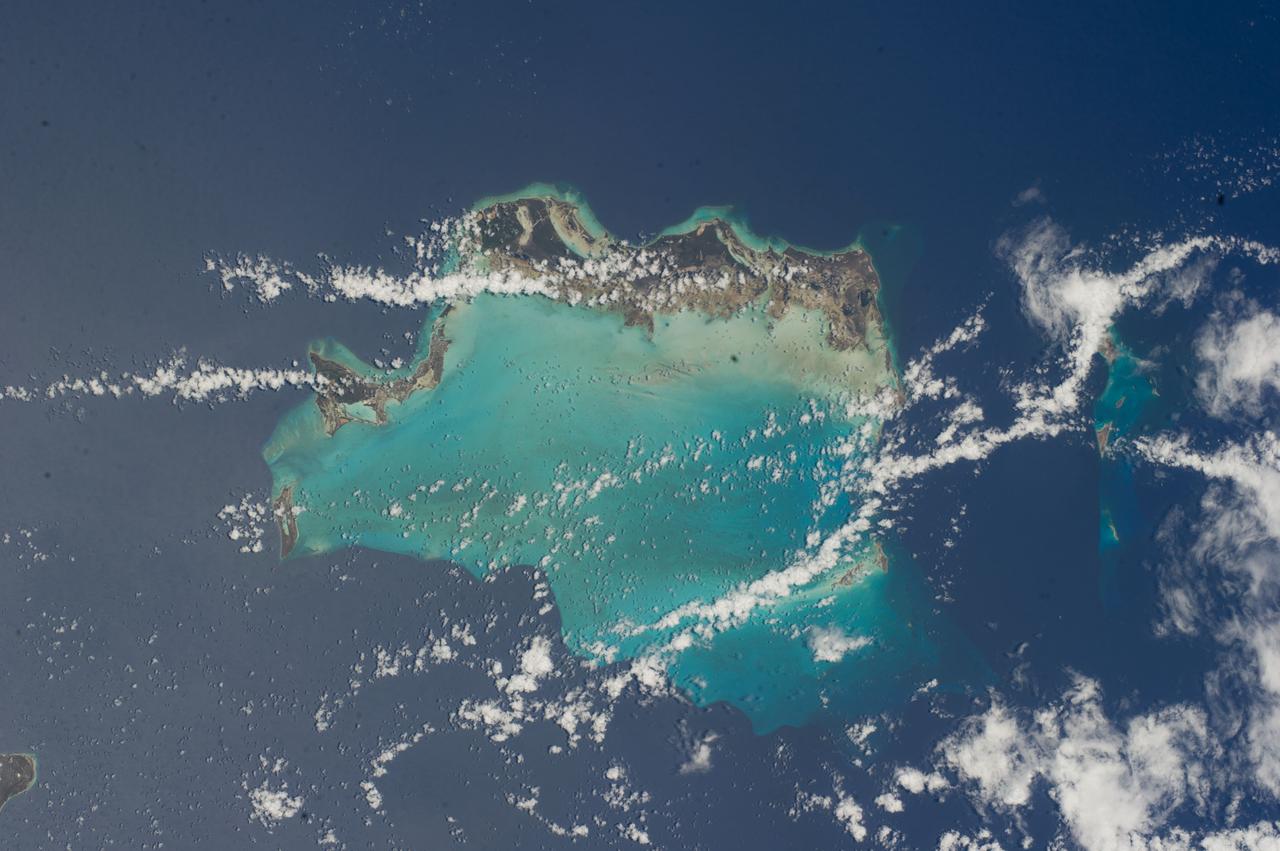ISS040-E-000478 (17 May 2014) --- One of the Expedition 40 crew members aboard the International Space Station used an 80mm lens on a digital still camera to photograph this image of the Turks and Caicos Islands. Those pictured include components of the Caicos -- Providenciales, North Caicos, Grand Caicos and East Caicos. The Turks Islands, including Grand Turk (under clouds), are on the right.