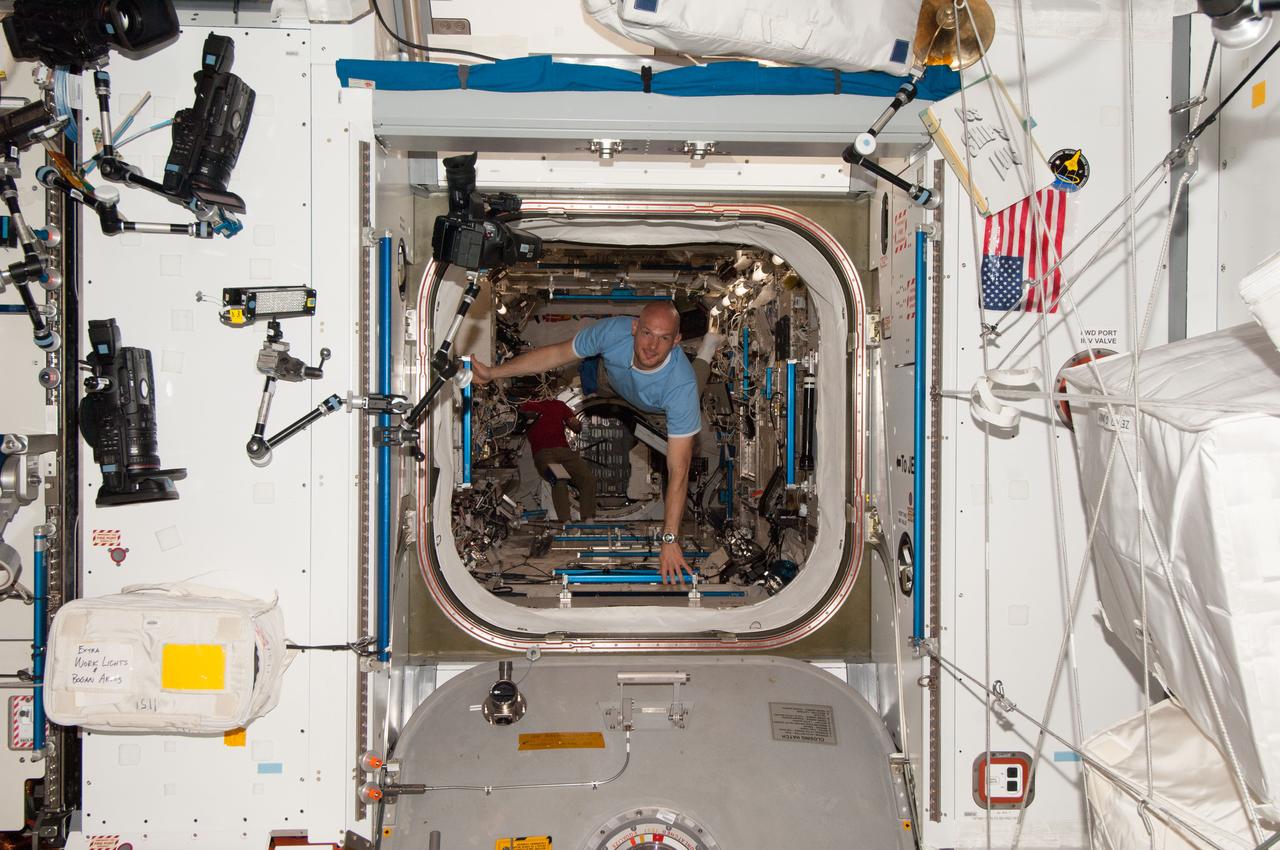 ISS040-E-006037 (30 May 2014) --- European Space Agency astronaut Alexander Gerst, Expedition 40 flight engineer, floats through the hatch between the Kibo laboratory and the Harmony node of the International Space Station.