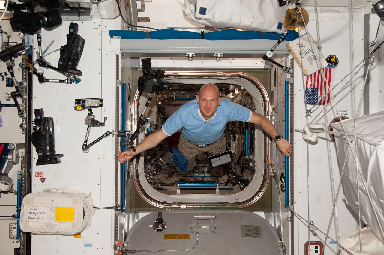 ISS040-E-006038 (30 May 2014) --- European Space Agency astronaut Alexander Gerst, Expedition 40 flight engineer, floats through the hatch between the Kibo laboratory and the Harmony node of the International Space Station.