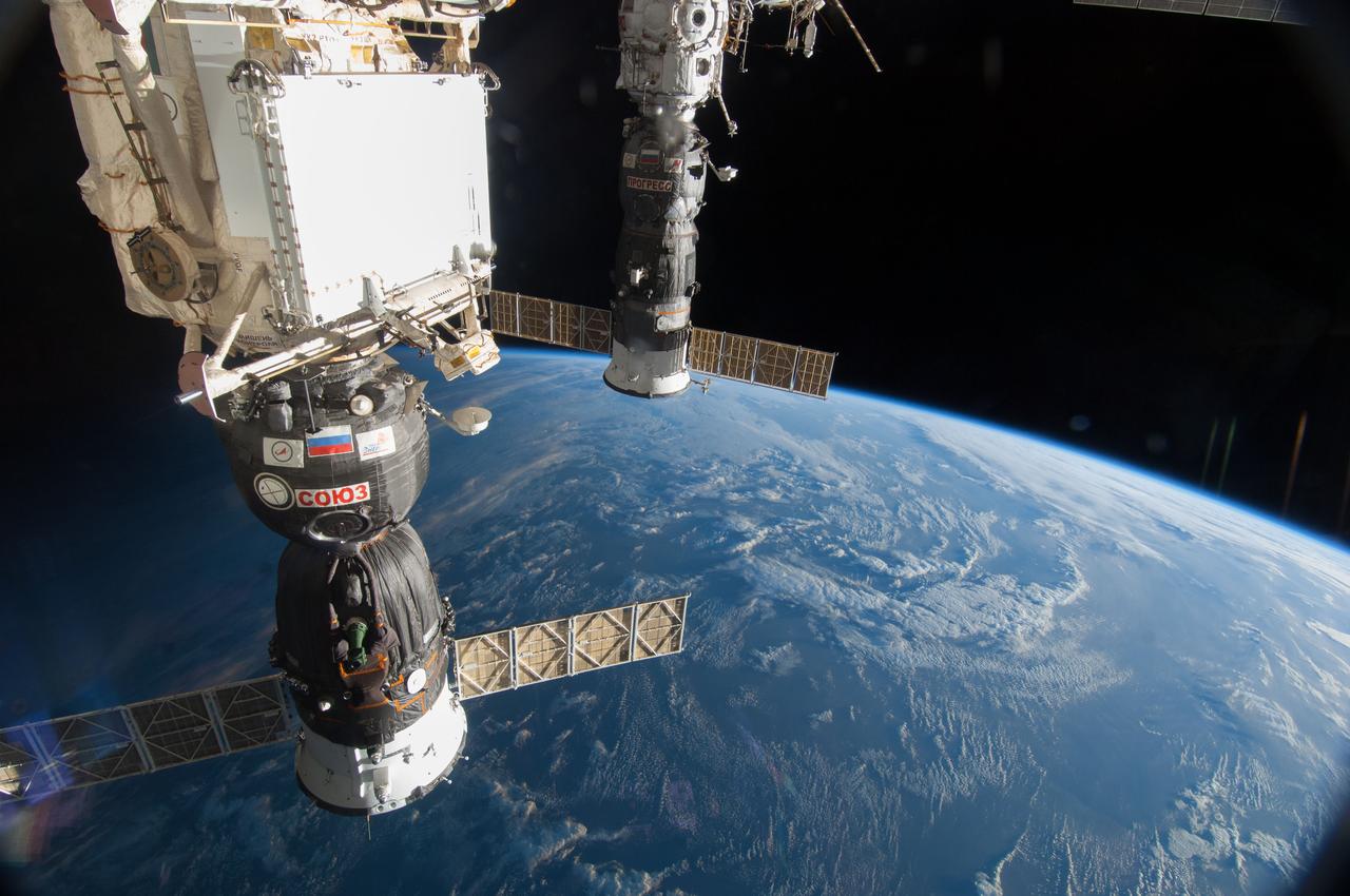 ISS040-E-006049 (30 May 2014) ---  The Russian Soyuz 39 spacecraft (foreground) and Progress 55 spacecraft, docked to the International Space Station, are featured in this image photographed by an Expedition 40 crew member on the space station. A blue and white part of Earth and the blackness of space provide the backdrop for the scene.
