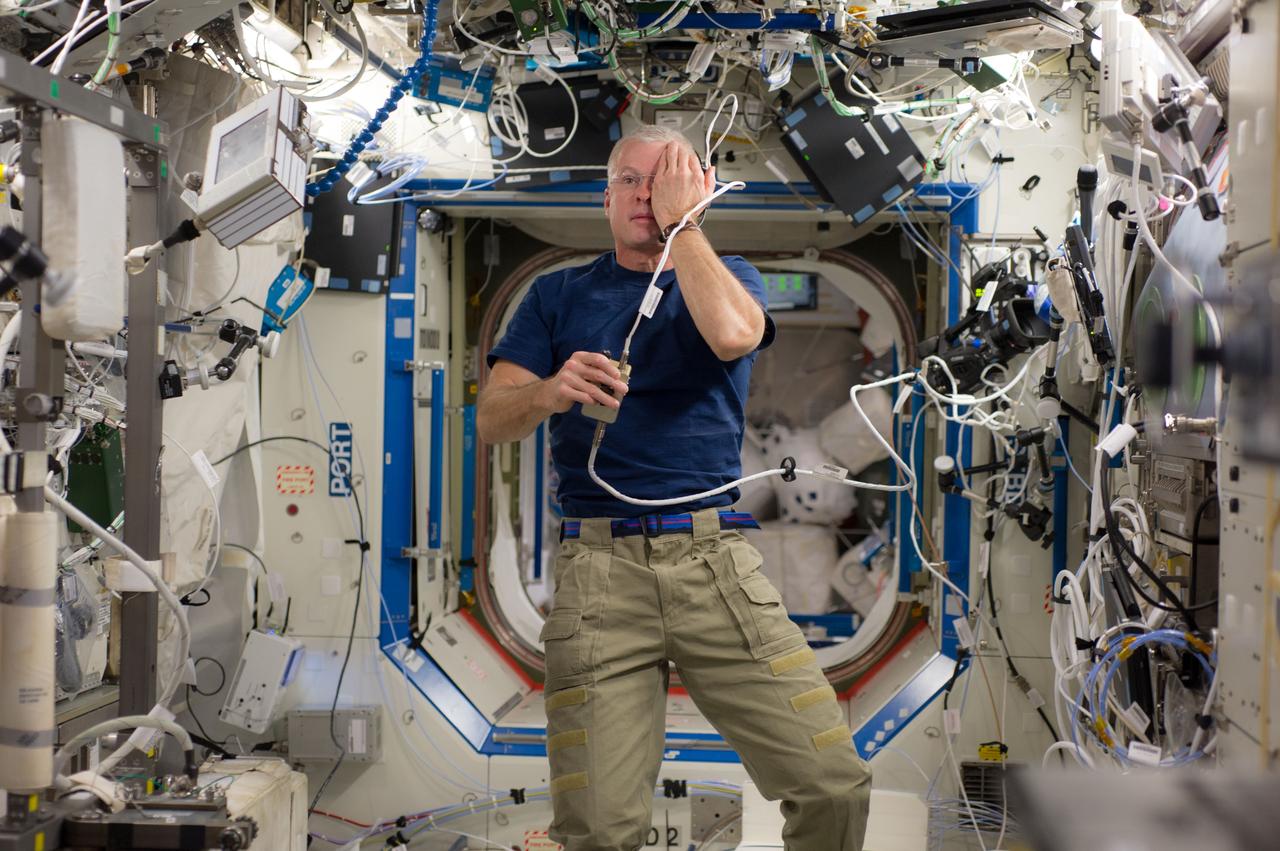 ISS040-E-006106 (2 June 2014) --- NASA astronaut Steve Swanson, Expedition 40 commander, performs a visual exam using an eye chart (out of frame) in the Destiny laboratory of the International Space Station.
