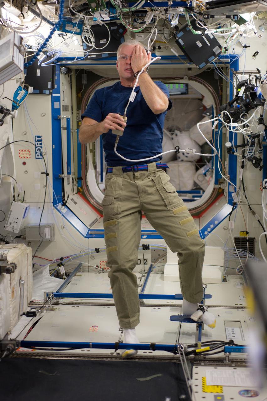 ISS040-E-006107 (2 June 2014) --- NASA astronaut Steve Swanson, Expedition 40 commander, performs a visual exam using an eye chart (out of frame) in the Destiny laboratory of the International Space Station.