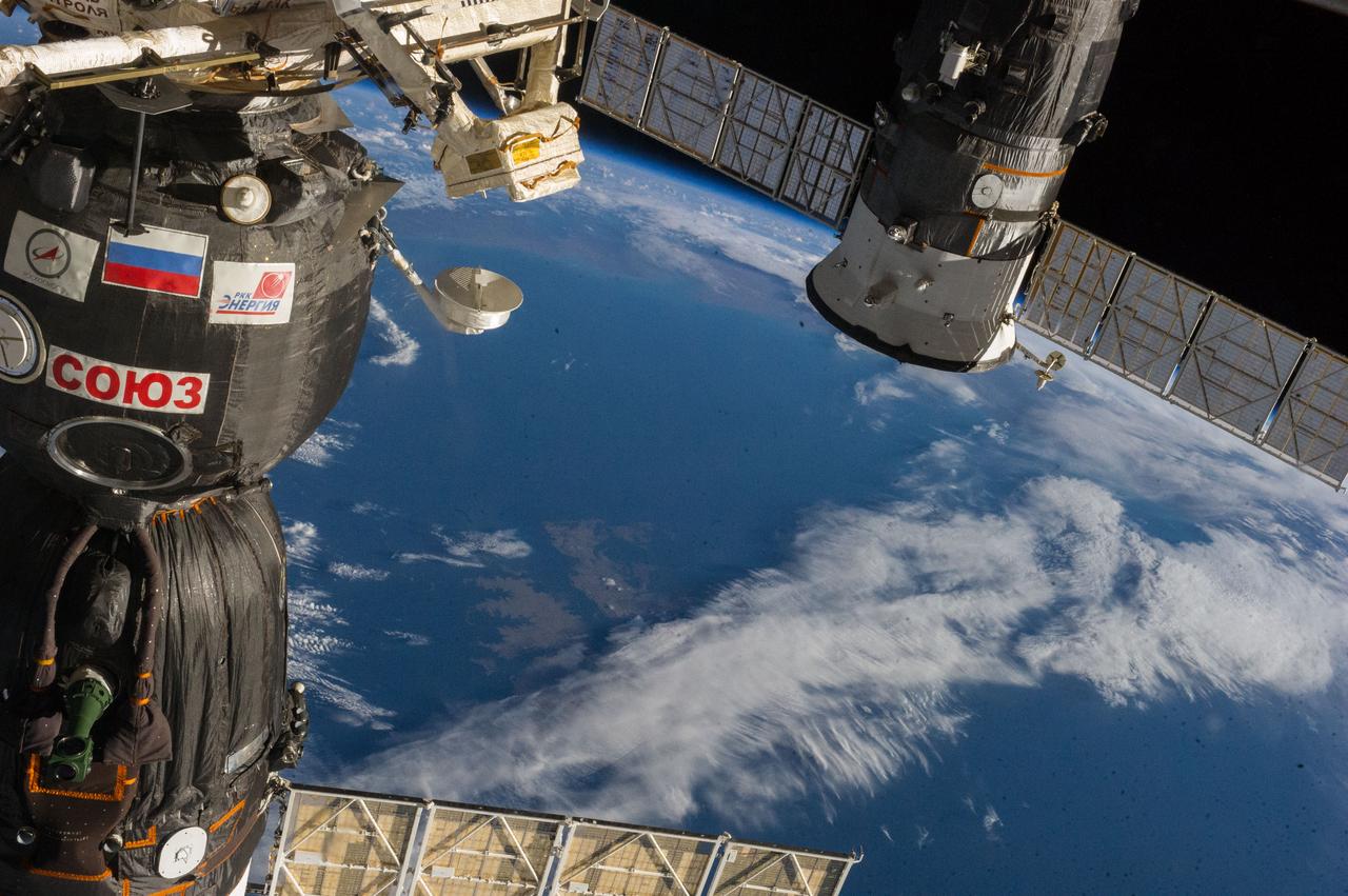 ISS040-E-006230 (30 May 2014) --- Two Russian spacecraft docked to the International Space Station are featured in this image photographed by an Expedition 40 crew member from inside the International Space Station?s Cupola. The Soyuz 39 (TMA-13M) spacecraft, docked to the Rassvet Mini-Research Module 1 (MRM1), is visible in the foreground. The Progress 55 resupply vehicle, docked to the Pirs Docking Compartment, is visible in the background. A blue and white part of Earth and the blackness of space provide the backdrop for the scene.
