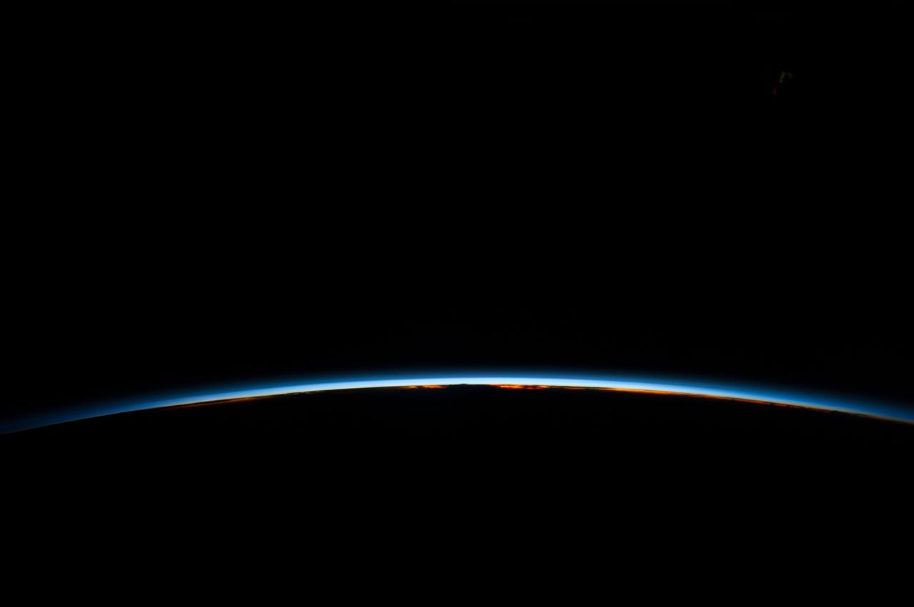 ISS040-E-006303 (31 May 2014) --- An orbital sunrise is featured in this image photographed by an Expedition 40 crew member on the International Space Station. Crew members onboard the space station see, on average, sixteen sunrises and sunsets during a 24-hour orbital period.