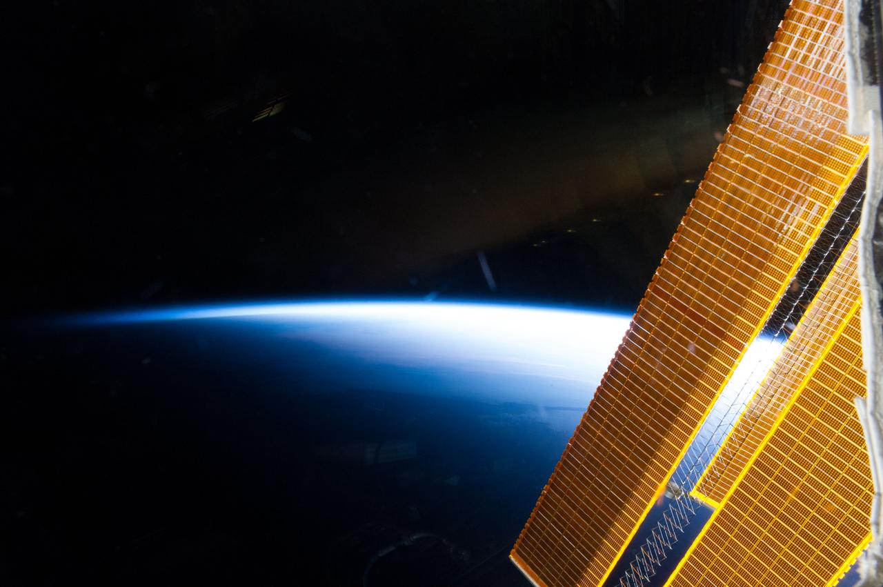 ISS040-E-006327 (1 June 2014) --- A portion of International Space Station solar array panels and Earth?s horizon are featured in this image photographed by an Expedition 40 crew member on the space station.