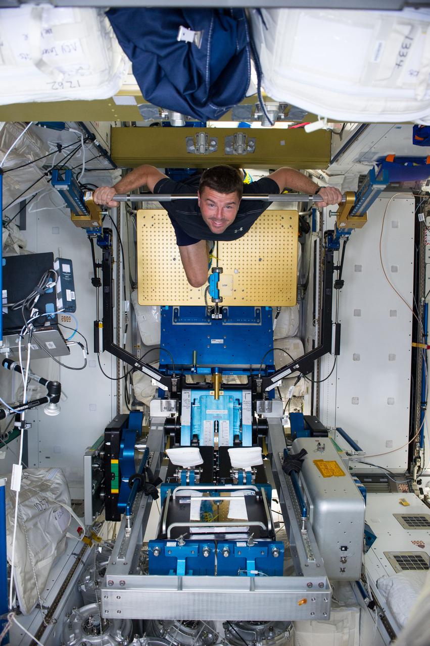 ISS040-E-006343 (1 June 2014) --- NASA astronaut Reid Wiseman, Expedition 40 flight engineer, gets a workout on the advanced Resistive Exercise Device (aRED) in the Tranquility node of the International Space Station.