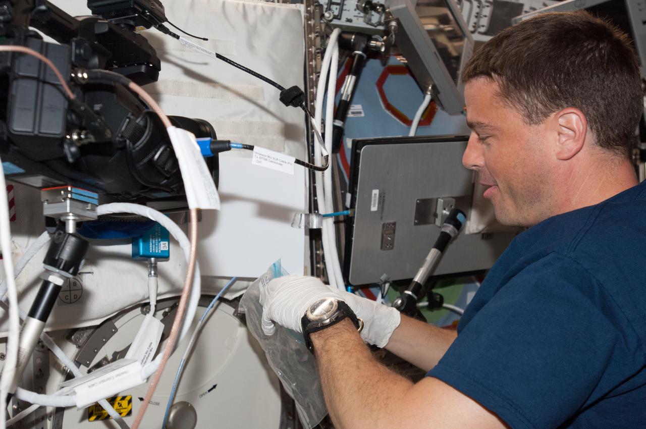 ISS040-E-006567 (2 June 2014) --- NASA astronaut Reid Wiseman, Expedition 40 flight engineer, performs an Advanced Colloids Experiment (ACE) sample 40-minute mixing activity in the Destiny laboratory of the International Space Station.
