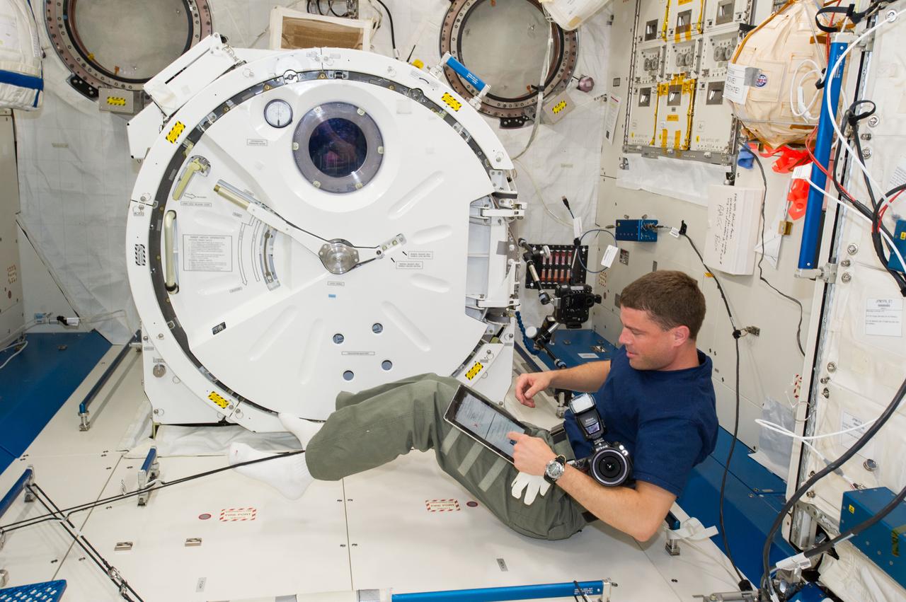 ISS040-E-006891 (3 June 2014) --- NASA astronaut Reid Wiseman, Expedition 40 flight engineer, conducts a session with the Binary Colloidal Alloy Test (BCAT) experiment in the Kibo laboratory of the International Space Station.