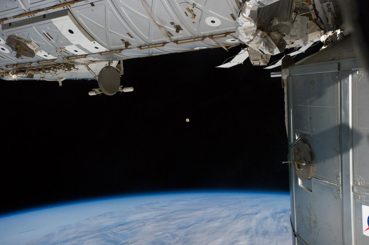 Earth Observation taken during a day pass by the Expedition 40 crew aboard the International Space Station (ISS). Folder lists this as: Moon, Japan, Kamchatka with a wild cloud. Part of the U.S. Lab and PMM are also visible.