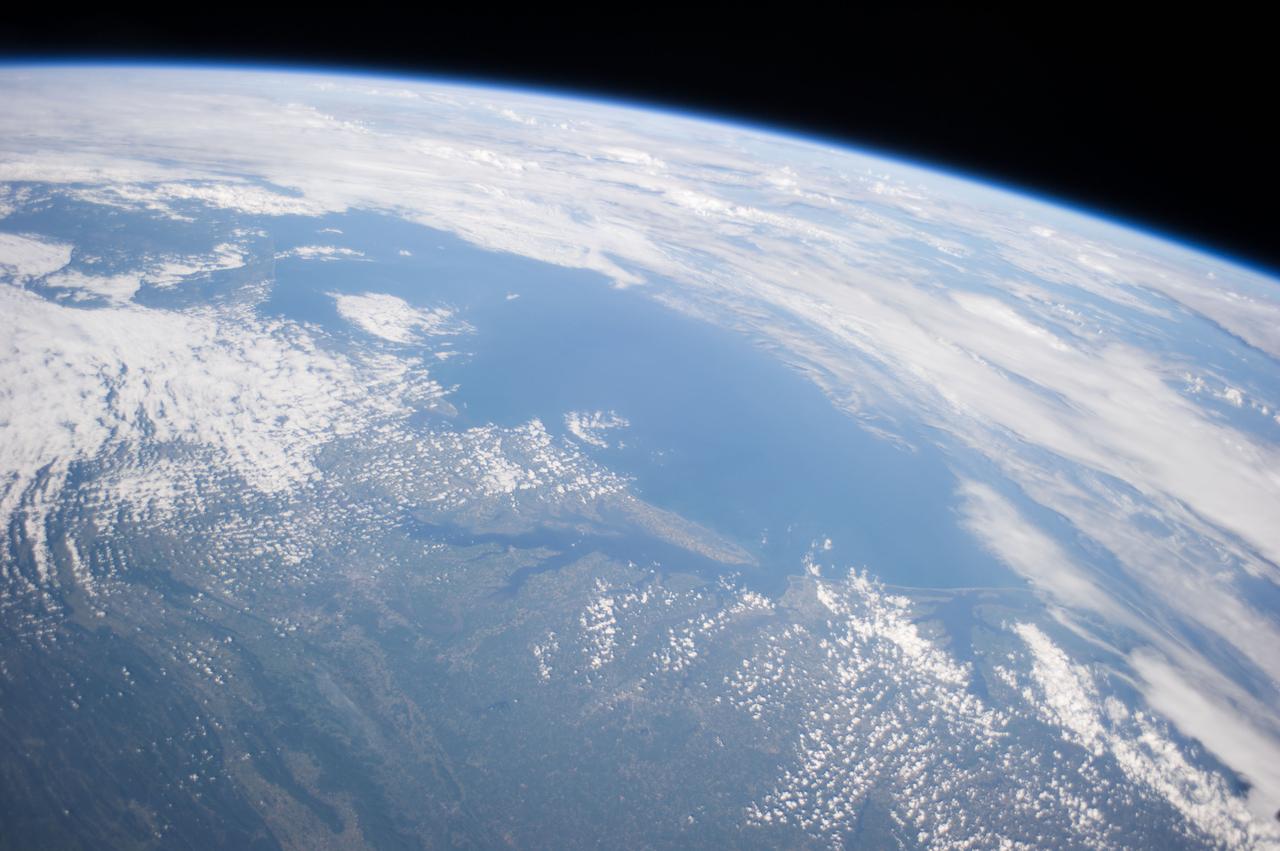 Earth Observation taken during a day pass by the Expedition 40 crew aboard the International Space Station (ISS). Folder lists this as: Eastern half of US, sun glint, Texas, Maryland, Mississippi river, Great Lakes.