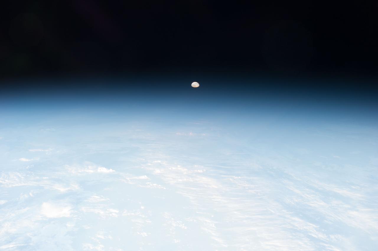 Earth observation taken during a day pass by the Expedition 40 crew aboard the International Space Station (ISS). Folder lists this as: Phenomenon over Northern Russia - 4 (plus Europe pass). Distant and hazy Moon is visible.