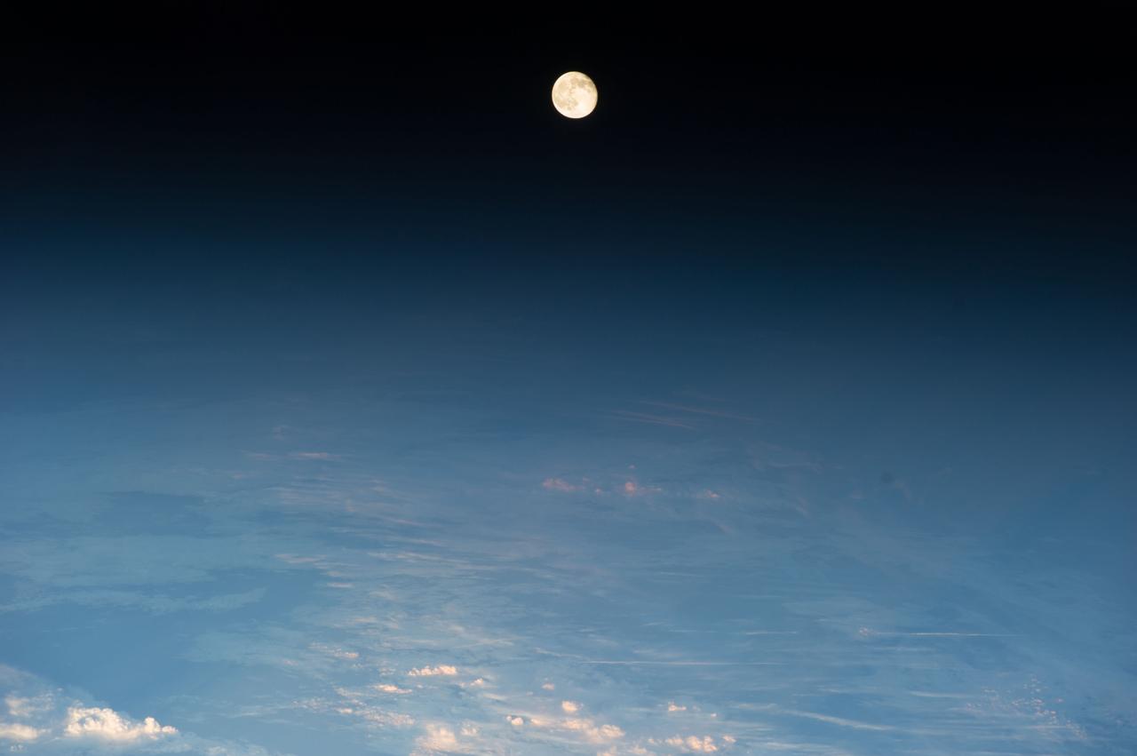 ISS040-E-012007 (14 June 2014) --- A waning gibbous moon is the central focus of this image taken by one of the Expedition 40 crew members aboard the Earth-orbiting International Space Station while the outpost was flying at an altitude of 219 nautical miles above eastern Europe. This image and the adjacent photograph (frame no. ISS04e012006) were taken only seconds apart but the moon appears larger in this frame because a 160mm focal length was used for this image and an 80mm lens was utilized for the other one.