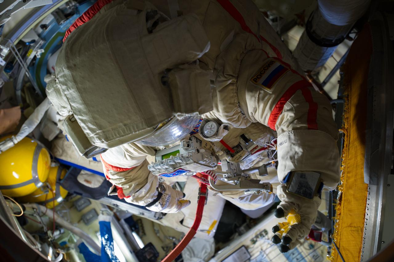 Photographic documentation of Russian ORLAN space suits in the Pirs Docking Compartment (DC1) ready for EVA 38 as photographed by the Expedition 40 crew.