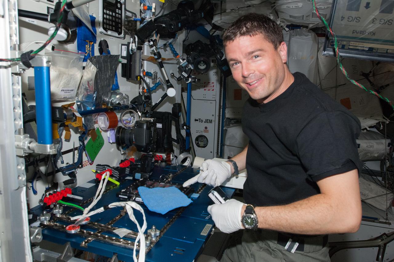 ISS040-E-013856 (17 June 2014) --- NASA astronaut Reid Wiseman, Expedition 40 flight engineer, conducts a session with the Binary Colloidal Alloy Test (BCAT) experiment at a workstation in the Harmony node of the International Space Station.