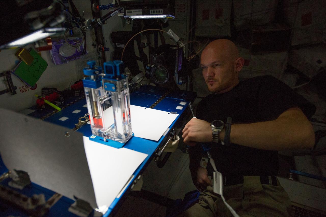 ISS040-E-015532 (19 June 2014) --- European Space Agency astronaut Alexander Gerst, Expedition 40 flight engineer, conducts a session with the Capillary Flow Experiment (CFE-2) in the Harmony node of the International Space Station. CFE is a suite of fluid physics experiments that investigate how fluids behave in microgravity which could benefit water and fuel delivery systems on future spacecraft. Scientists designed the CFE-2 to study properties of fluids and bubbles inside containers with a specific 3-D geometry.