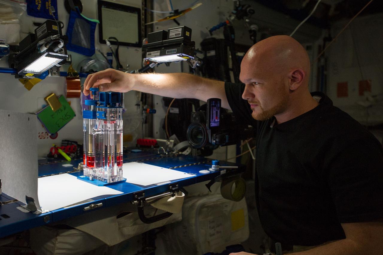 ISS040-E-015543 (19 June 2014) --- European Space Agency astronaut Alexander Gerst, Expedition 40 flight engineer, conducts a session with the Capillary Flow Experiment (CFE-2) in the Harmony node of the International Space Station. CFE is a suite of fluid physics experiments that investigate how fluids behave in microgravity which could benefit water and fuel delivery systems on future spacecraft. Scientists designed the CFE-2 to study properties of fluids and bubbles inside containers with a specific 3-D geometry.