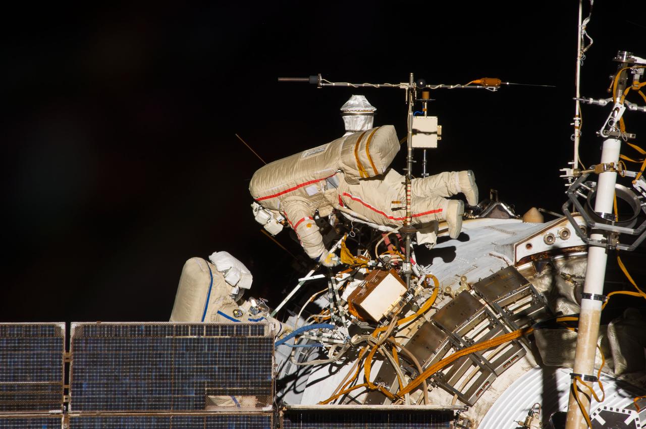ISS040-E-015644 (19 June 2014) --- Russian cosmonauts Alexander Skvortsov (right) and Oleg Artemyev, both Expedition 40 flight engineers, participate in a session of extravehicular activity (EVA) as work continues on the International Space Station. During the seven-hour, 23-minute spacewalk Skvortsov and Artemyev completed installation and experiment tasks outside the station’s Russian segment.