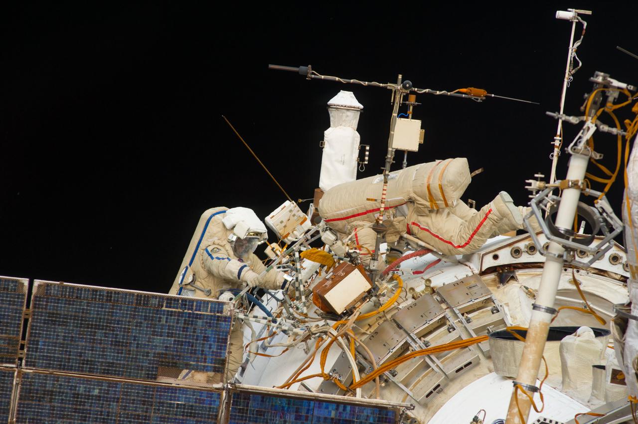 ISS040-E-015669 (19 June 2014) --- Russian cosmonauts Alexander Skvortsov (right) and Oleg Artemyev, both Expedition 40 flight engineers, participate in a session of extravehicular activity (EVA) as work continues on the International Space Station. During the seven-hour, 23-minute spacewalk Skvortsov and Artemyev completed installation and experiment tasks outside the station’s Russian segment.