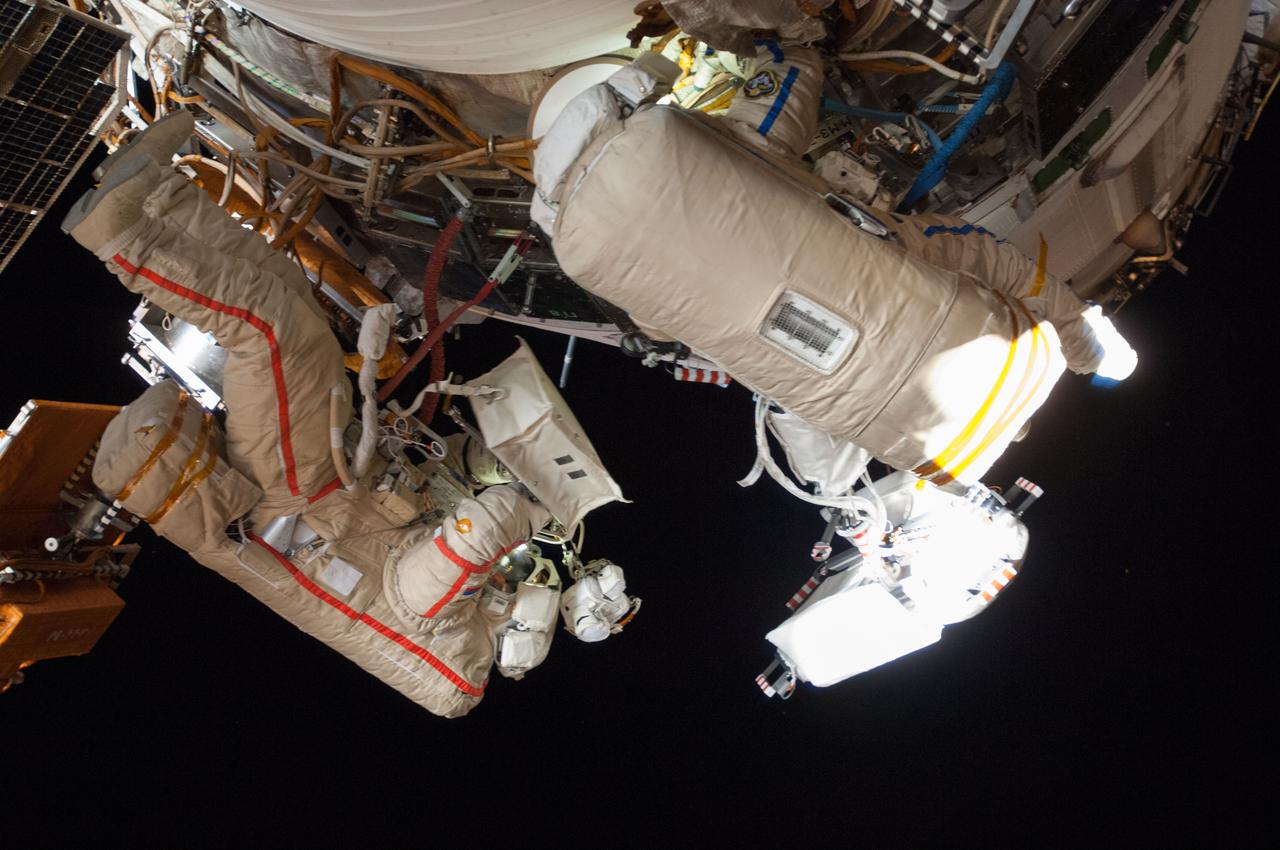 ISS040-E-015721 (19 June 2014) --- Russian cosmonauts Alexander Skvortsov (left) and Oleg Artemyev, both Expedition 40 flight engineers, participate in a session of extravehicular activity (EVA) as work continues on the International Space Station. During the seven-hour, 23-minute spacewalk Skvortsov and Artemyev completed installation and experiment tasks outside the station’s Russian segment.