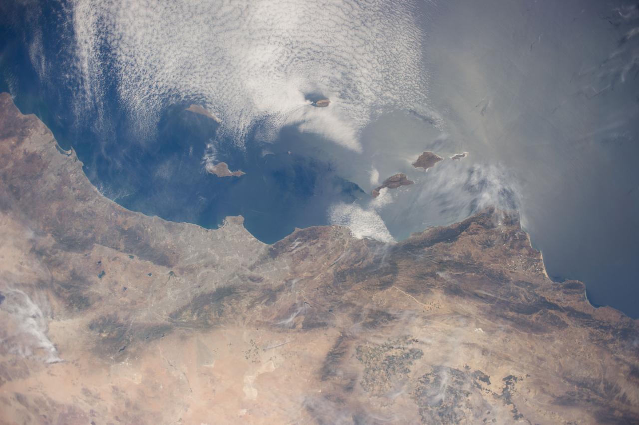 ISS040-E-016422 (20 June 2014) --- One of the Expedition 40 crew members aboard the International Space Station used a 28mm focal length to record this long stretch of California's Pacific Coast on June 20, 2014. Guadalupe Island and the surrounding von Karman cloud vortices over the Pacific can be seen just above frame center. San Diego is visible in upper left and the Los Angeles Basin is just to the left of center frame. Much of the Mojave Desert is visible in bottom frame.