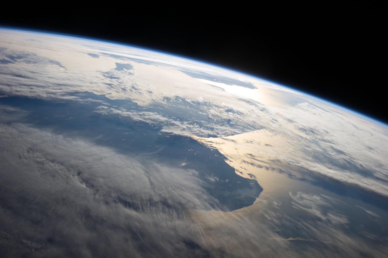 Earth Observation taken during a day pass by the Expedition 40 crew aboard the International Space Station (ISS). Folder lists this as:  Uruguay Argentina sun glint coastlines. Also sent down via Twitter message: This was the Argentina coastline a few hours ago.