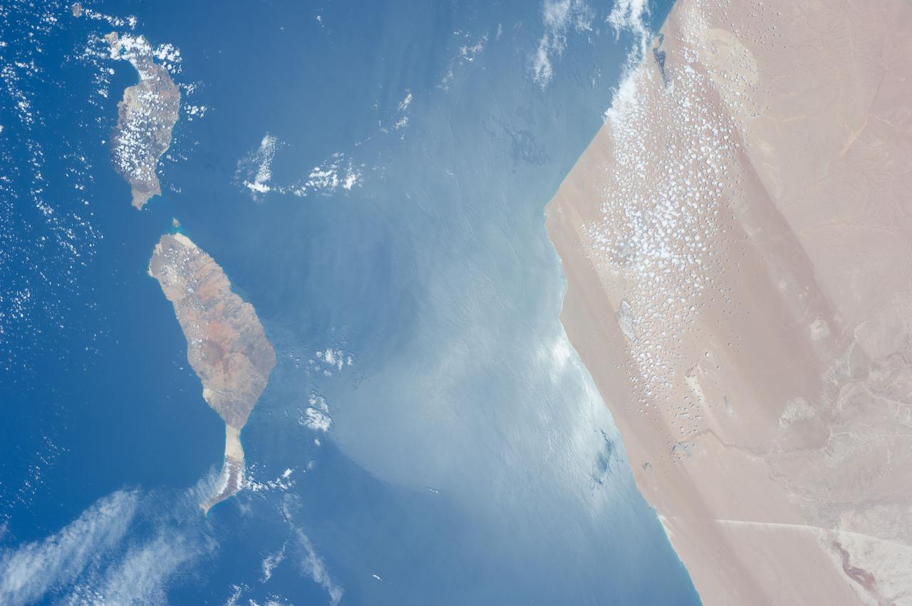 ISS040-E-017303 (23 June 2014) --- One of the Expedition 40 crew members aboard the Earth-orbiting International Space Station, flying approximately 223 nautical miles above the Atlantic Ocean photographed this image featuring the Atlantic coasts of the northwest African nation of Morocco and the disputed territory of Western Sahara. Two islands in the Canary Islands chain are pictured. Gran Canaria is just out of the frame at left.