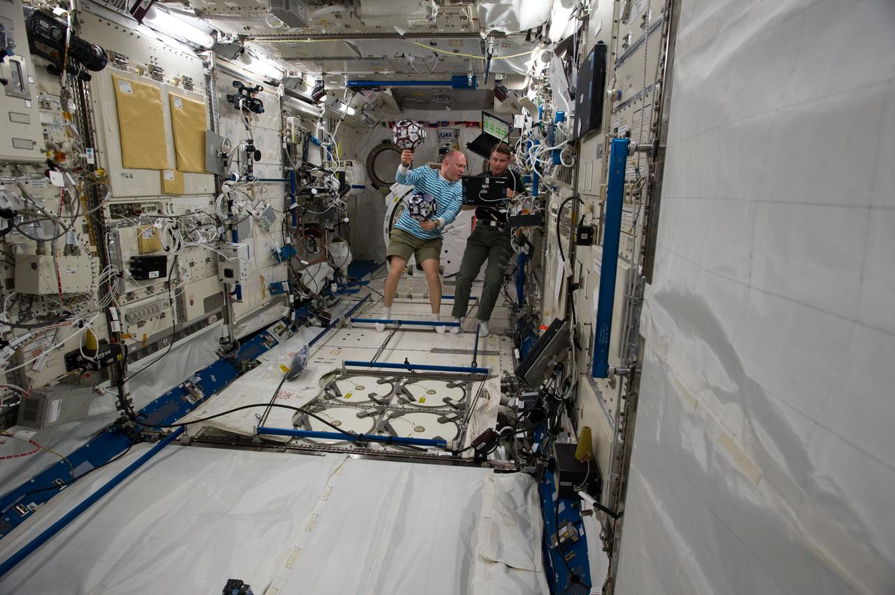 ISS040-E-018383 (24 June 2014) --- Russian cosmonaut Oleg Artemyev (left) and NASA astronaut Reid Wiseman, both Expedition 40 flight engineers, conduct a session of the Synchronized Position Hold, Engage, Reorient, Experimental Satellites Zero Robotics (SPHERES ZR) program in the Kibo laboratory of the International Space Station.