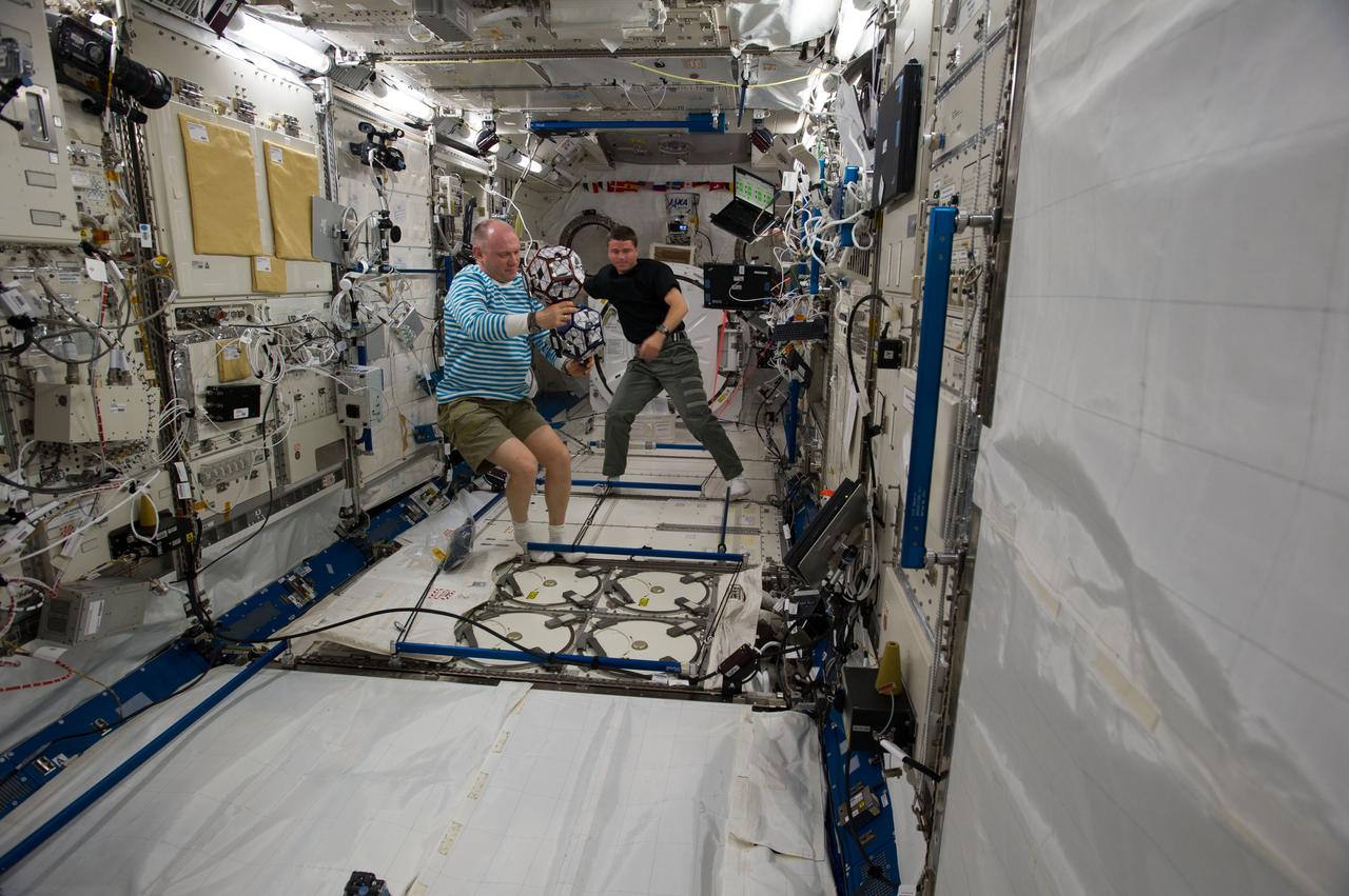ISS040-E-018572 (24 June 2014) --- Russian cosmonaut Oleg Artemyev (left) and NASA astronaut Reid Wiseman, both Expedition 40 flight engineers, conduct a session of the Synchronized Position Hold, Engage, Reorient, Experimental Satellites Zero Robotics (SPHERES ZR) program in the Kibo laboratory of the International Space Station.