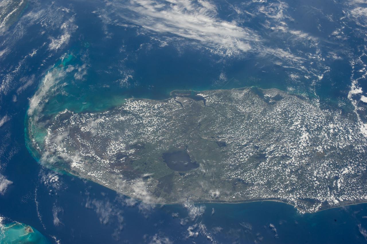 ISS040-E-018725 (24 June 2014) --- One of the Expedition 40 crew members aboard the Earth-orbiting International Space Station photographed this image featuring most of the peninsular portion of the state of Florida. Lake Okeechobee stands out in the south central part of the state. The heavily-populated area of Miami can be traced along the Atlantic Coast near the bottom of the scene. Cape Canaveral and the Kennedy Space Center are in lower right portion of the image on the Atlantic Coast.  The Florida Keys are at the south (left) portion of the scene and the Gulf Coast, including the Tampa-St. Petersburg area, is near frame center.