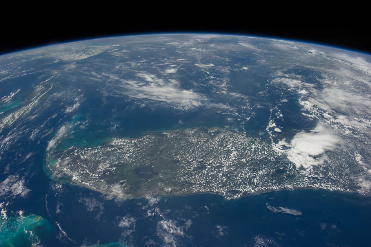 ISS040-E-018729 (24 June 2014) --- One of the Expedition 40 crew members aboard the Earth-orbiting International Space Station photographed this image featuring the peninsular portion of the state of Florida. Lake Okeechobee stands out in the south central part of the state. The heavily-populated area of Miami can be traced along the Atlantic Coast near the bottom of the scene. Cape Canaveral and the Kennedy Space Center are just below center frame on the Atlantic Coast.  The Florida Keys are at the south (left) portion of the scene and the Gulf Coast, including the Tampa-St. Petersburg area, is near frame center.
