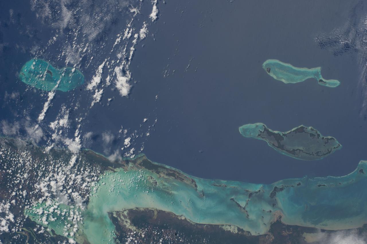 ISS040-E-018752 (24 June 2014) --- One of the Expedition 40 crew members aboard the International Space Station, flying at an altitude of 223 nautical miles, photographed this image of the Caribbean Coast of Belize near the point where it borders Mexico's Yucatan Peninsula. Belize has more than 200 islands or ?cayes.?