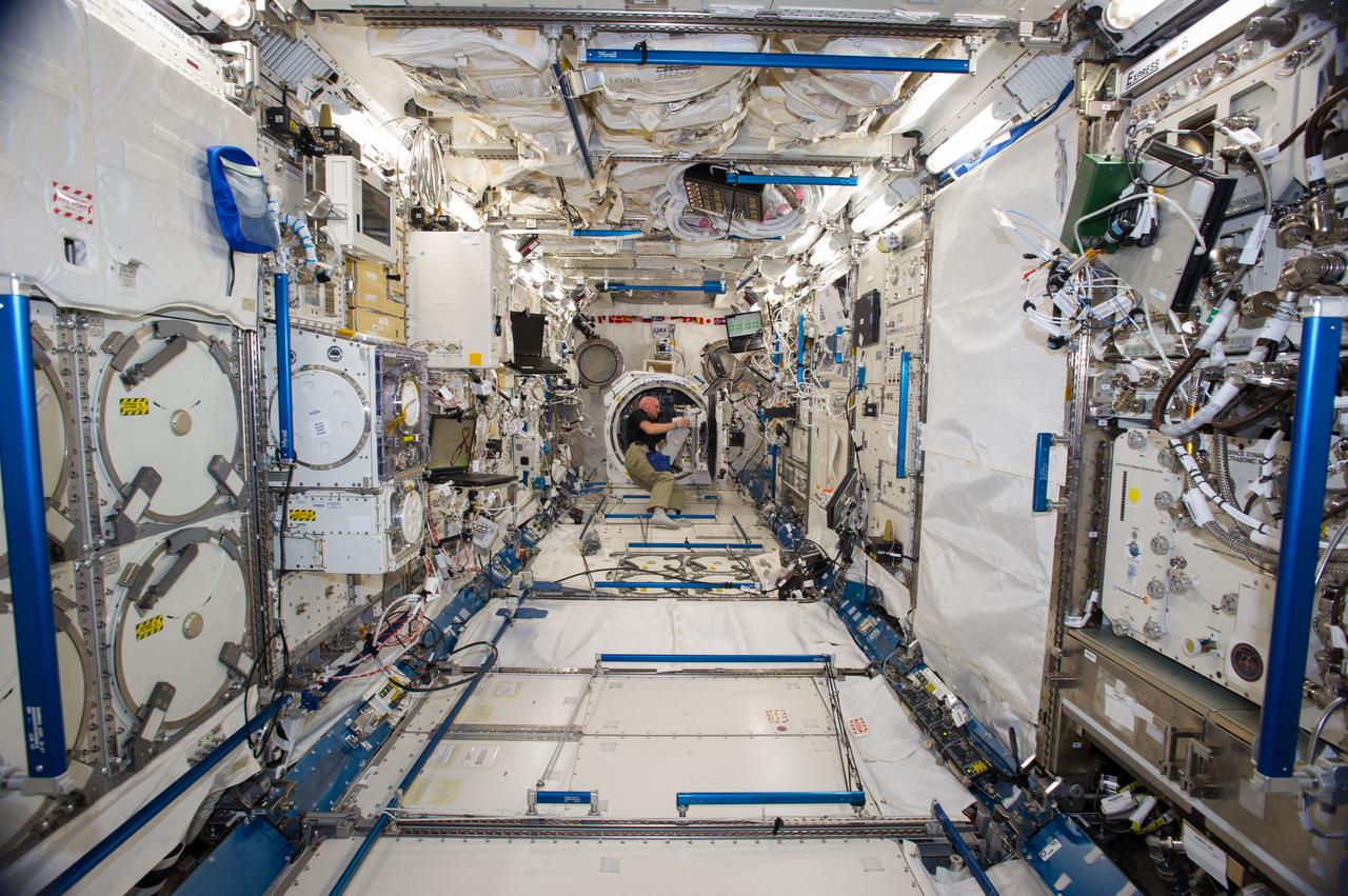 ISS040-E-019299 (25 June 2014) --- In the International Space Station?s Kibo laboratory, European Space Agency astronaut Alexander Gerst, Expedition 40 flight engineer, prepares to transfer a multi-purpose experiment platform and a robotic arm known as the Small Fine Arm through the Kibo module?s scientific airlock. The Small Fine Arm, which attaches to the Kibo?s larger main arm, handles delicate operations involved in exchanging experiments and payloads located on the Exposed Facility.