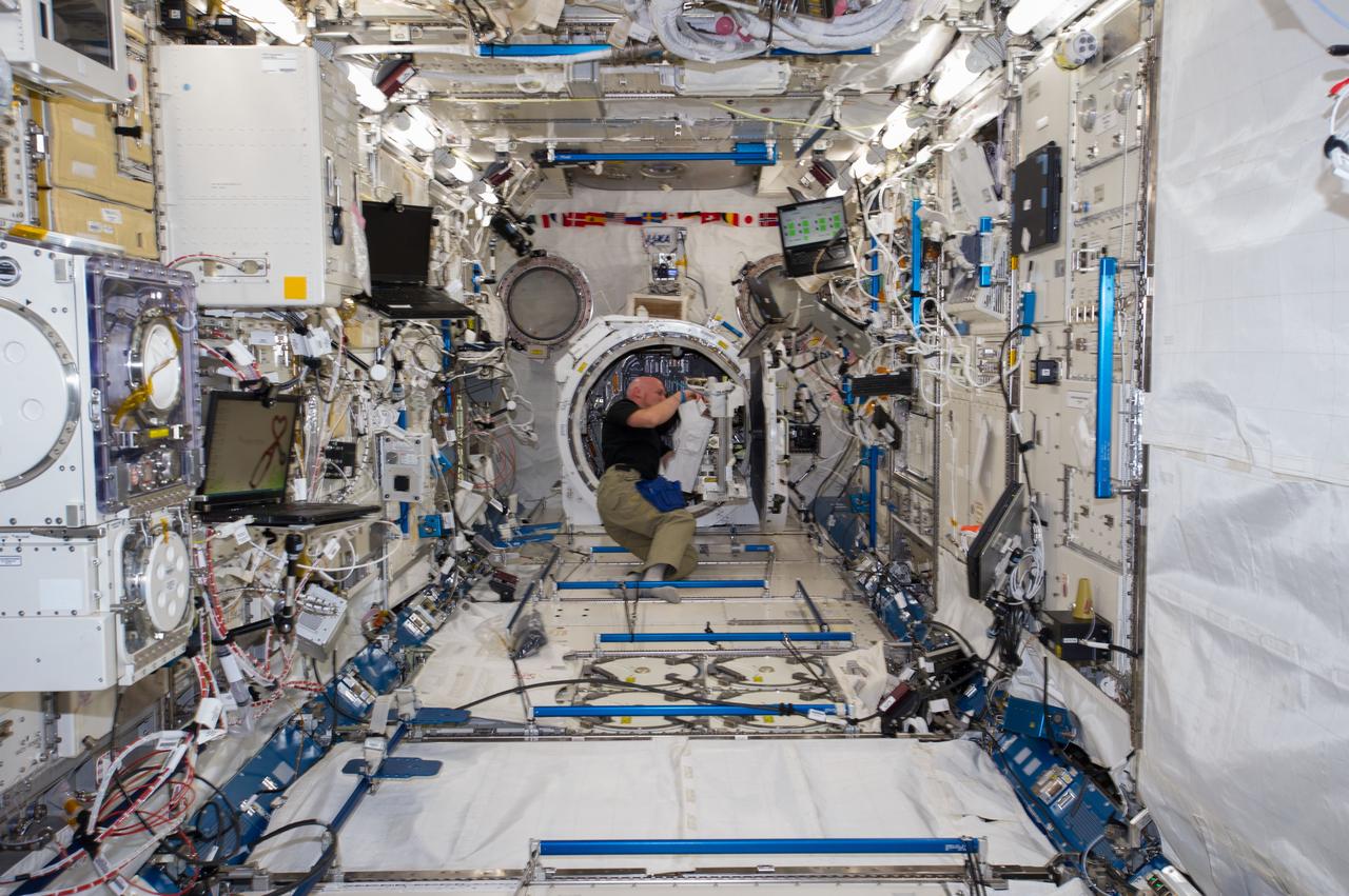 ISS040-E-019300 (25 June 2014) --- In the International Space Station?s Kibo laboratory, European Space Agency astronaut Alexander Gerst, Expedition 40 flight engineer, prepares to transfer a multi-purpose experiment platform and a robotic arm known as the Small Fine Arm through the Kibo module?s scientific airlock. The Small Fine Arm, which attaches to the Kibo?s larger main arm, handles delicate operations involved in exchanging experiments and payloads located on the Exposed Facility.