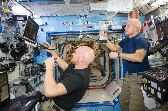 NASA image: Expedition 40 crew in Node 2 after German - U.S. soccer game